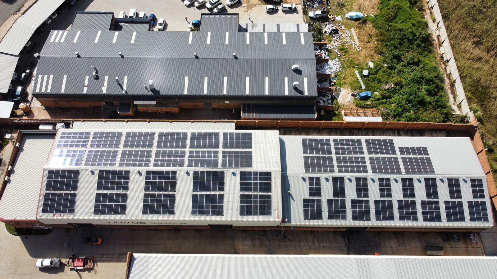 Aerial view of commercial rooftops fitted with solar panels