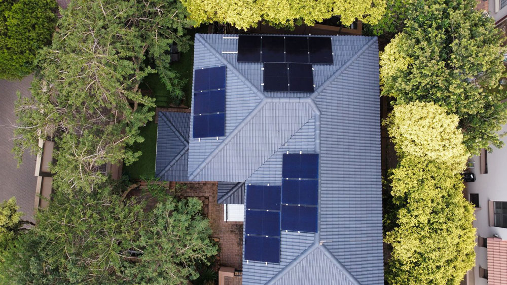 Aerial view of a home with solar panels on its roof